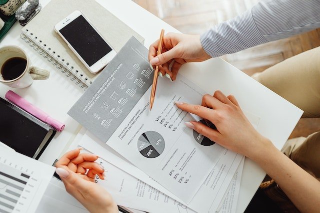 a-person-reading-data-documents-at-a-desk