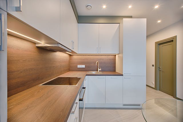 kitchen-with-wood-countertops-and-white-cupboards